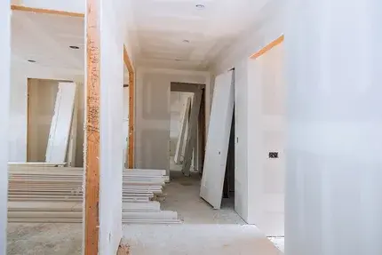 Technician patching a damaged interior drywall wall in a Tampa home