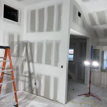 Water-damaged drywall section cut out and ready for replacement