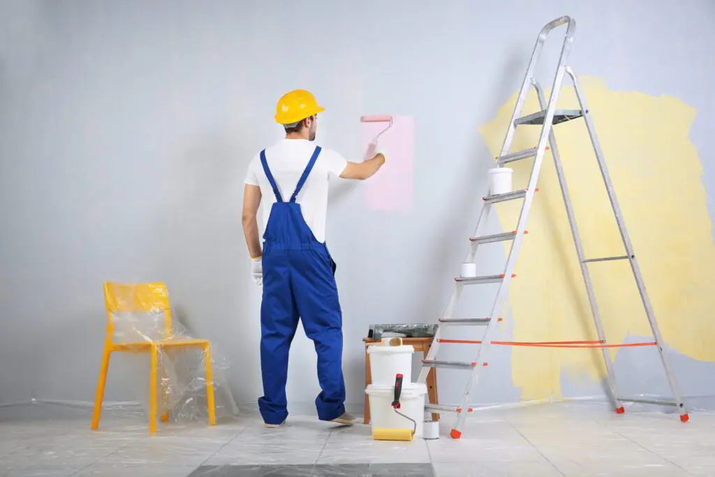 Painter rolling a fresh coat on a smooth interior wall in a Tampa home