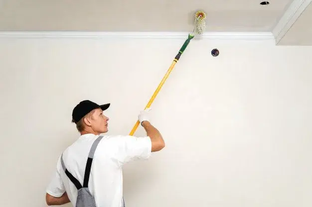 Freshly patched and primed square of drywall on a living room wall